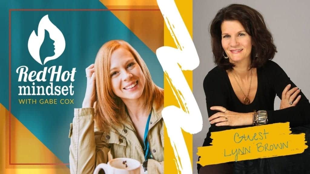 red hot mindset podcast cover photo (white red hot mindset logo with a face in a flame, woman smiling with medium red hair and one hand in her hair and khaki jacket, teal and yellow background), on right side is a woman with medium-length dark brown hair sitting with her arms crossed and smiling. She is wearing a long-sleeve black shirt and leaning on a chair. She is wearing a long gold chain necklace with a pendant and a few gold bracelets of various sizes.