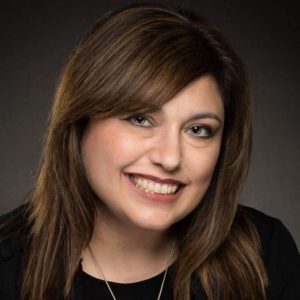 headshot of a woman with long brown hair smiling