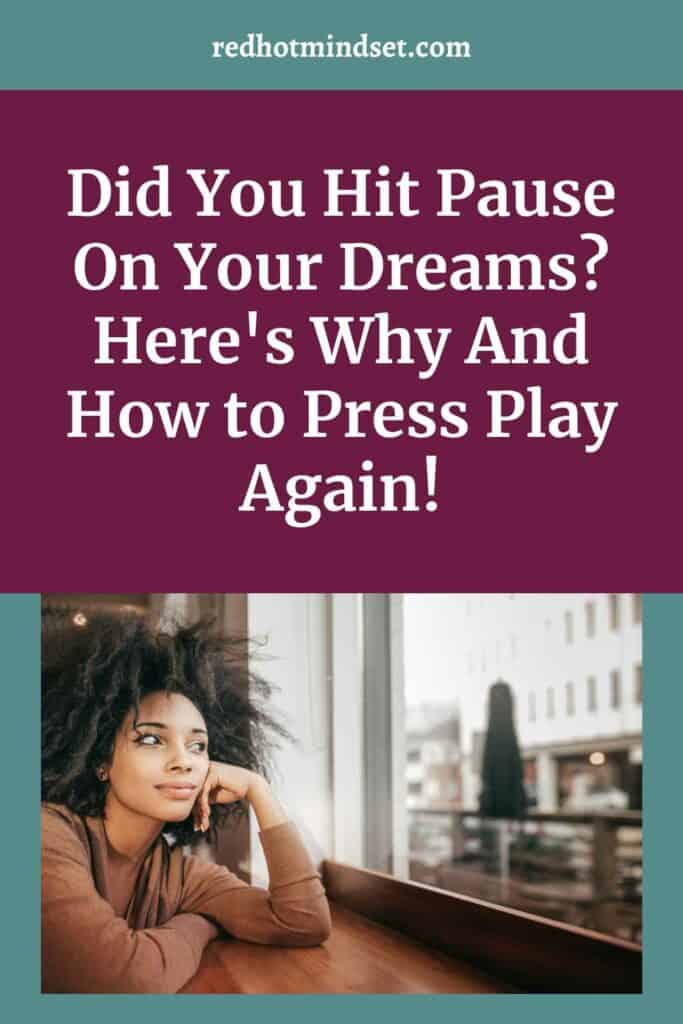 Woman with shorter black curly hair sitting with her arm up on a ledge near a window and staring off as if she's contemplating something. Pinterest cover says Did You Hit Pause On Your Dreams? Here's Why And How to Press Play Again!