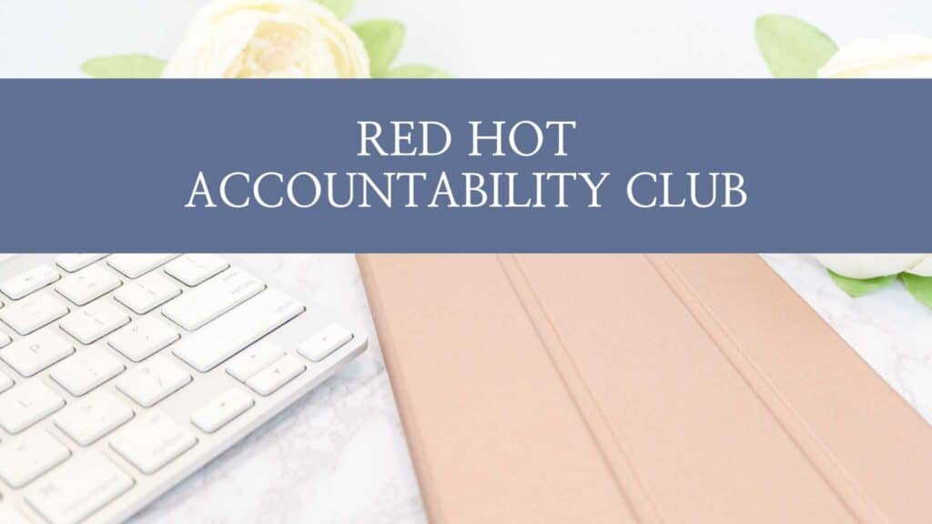 Graphic of a computer and notebook on a desk with "red hot accountability club" written across it