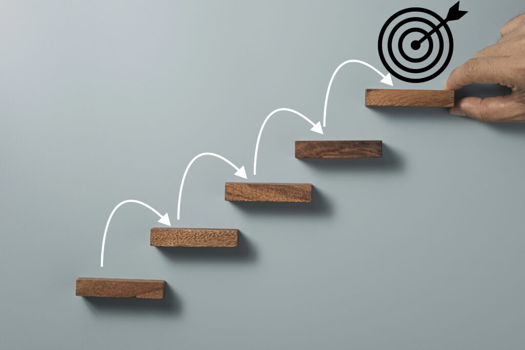 growth-image-with-arrows-leading-up-a-wooden-path-to-the-bulls-eye-scaled