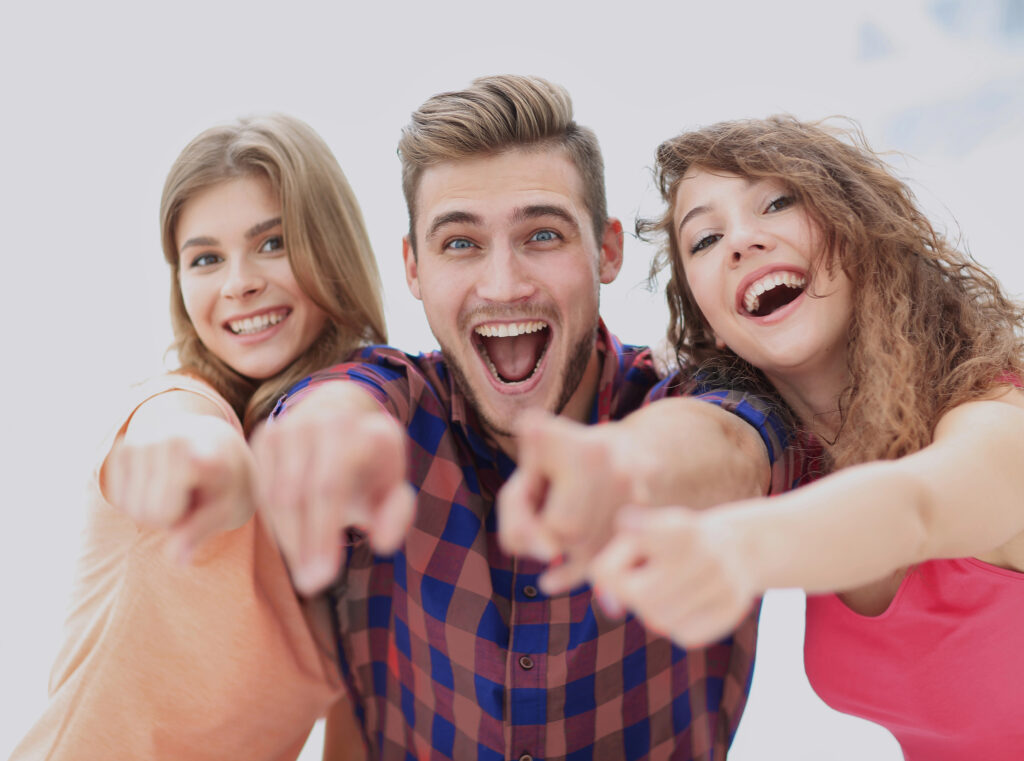 Closeup of three happy young people showing hands forward — Photo